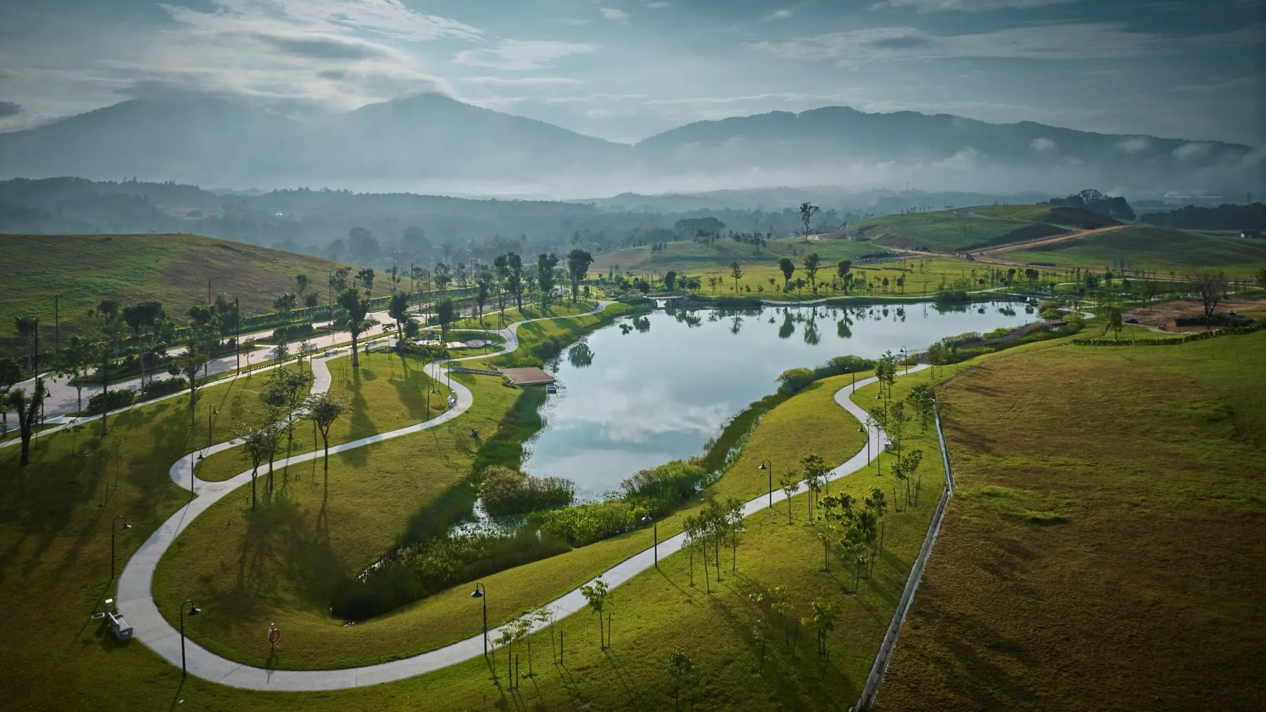 Actual photograph of the lake, path and hills at Anyara Hills