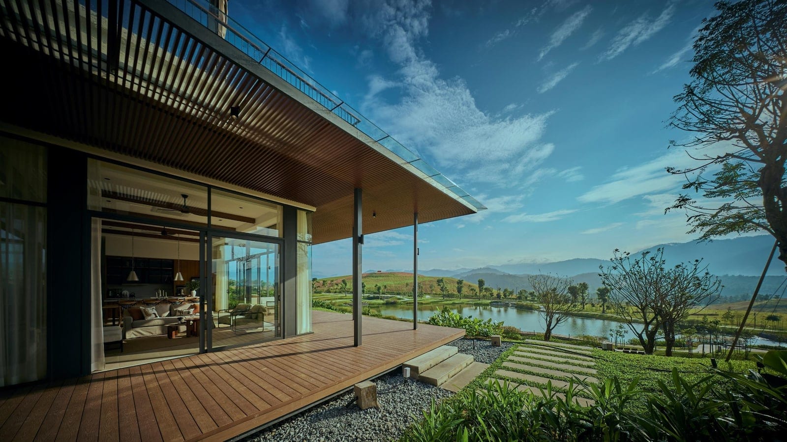 Veranda and glass living-room frontage overlooking the lake at Anyara Hills